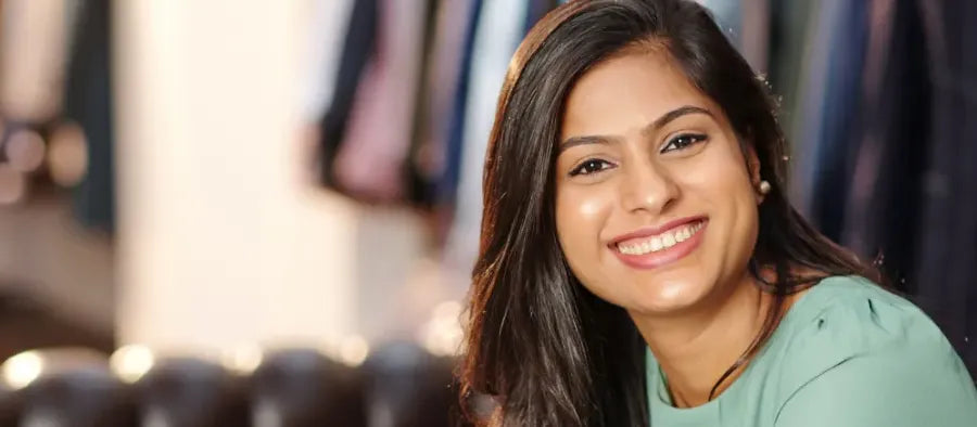 A person applying serum to their skin, exploring options for pigmentation removal and skin care solutions.