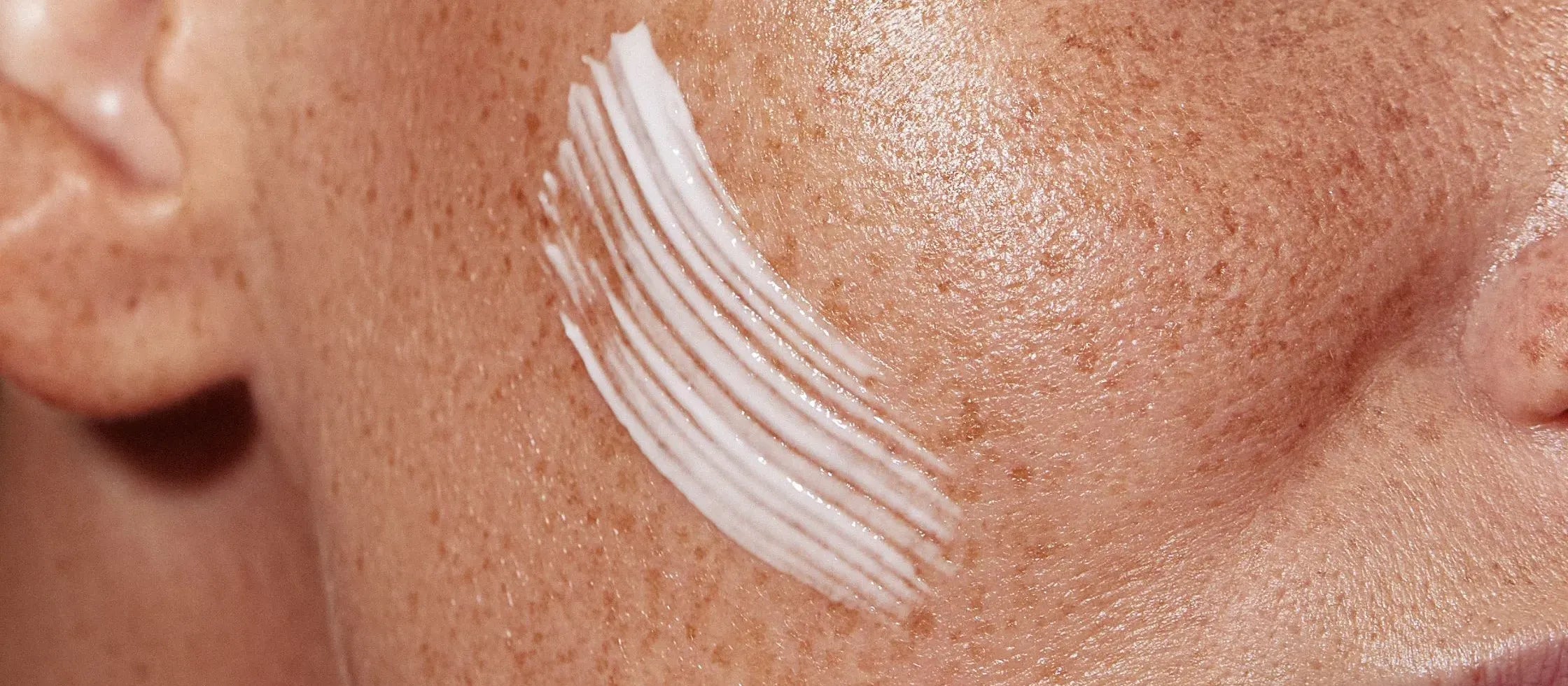 A person applying gel sunscreen on their skin, highlighting its lightweight texture and skin benefits.