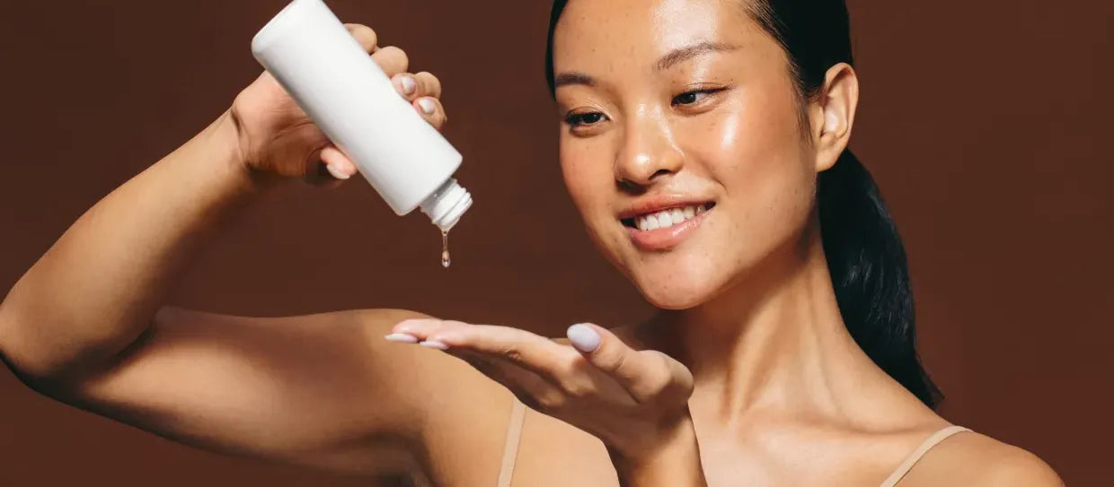 A person applying SPF 50 sunscreen on oily skin, showcasing its lightweight, non-greasy formula for sun protection.