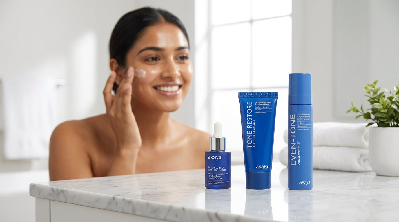 A smiling young indian woman applying skincare in a bright, minimal bathroom, holding a premium skincare set on a clean vanity, soft natural lighting, fresh glowing skin, elegant and aesthetic. 