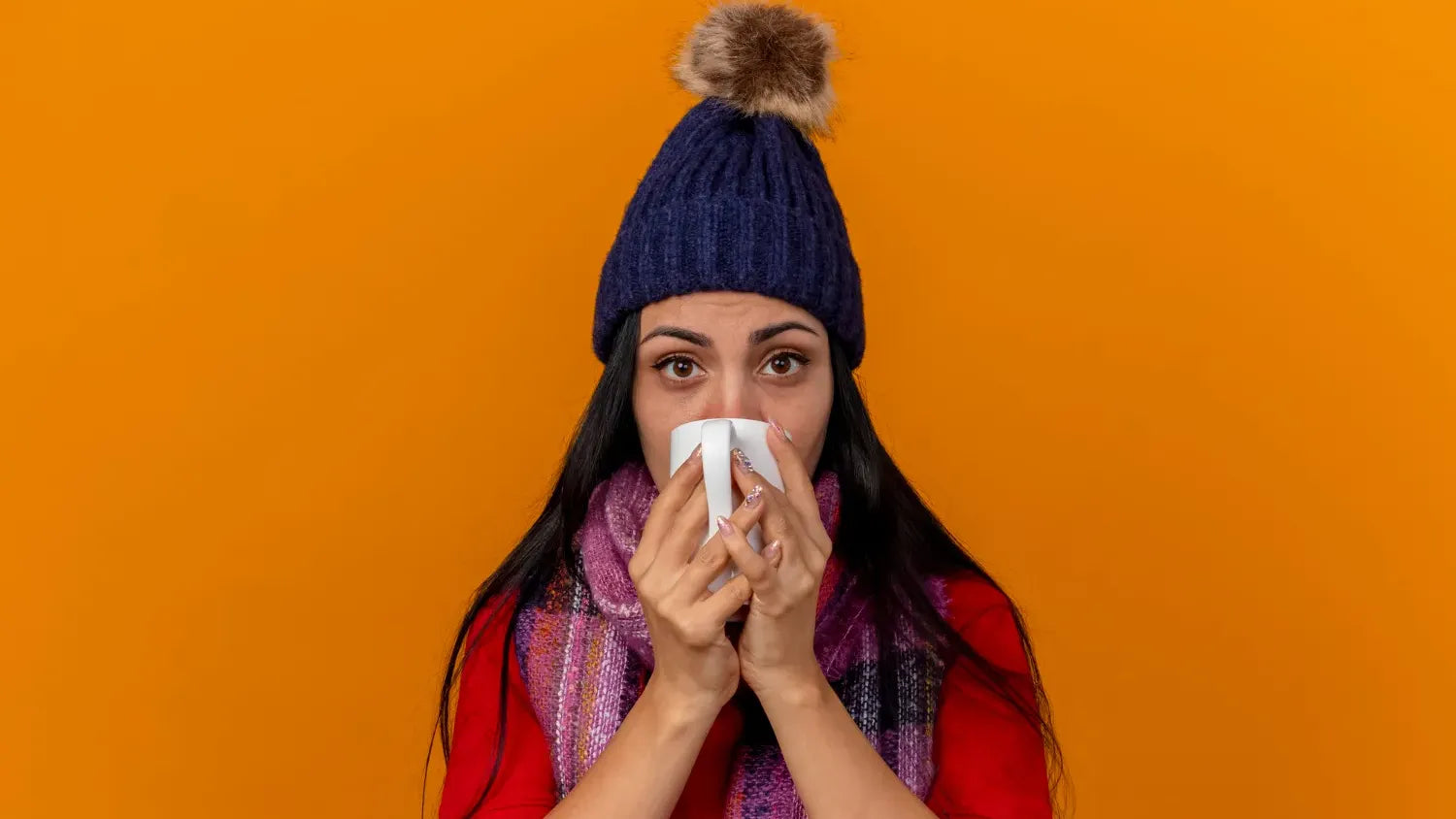 A cozy scene showing a person applying a natural moisturizer for dry skin during winter months.