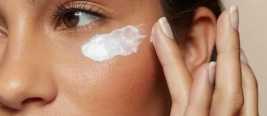 Three sunscreen bottles on a beach towel, suitable for various skin types, highlighting sun protection options.