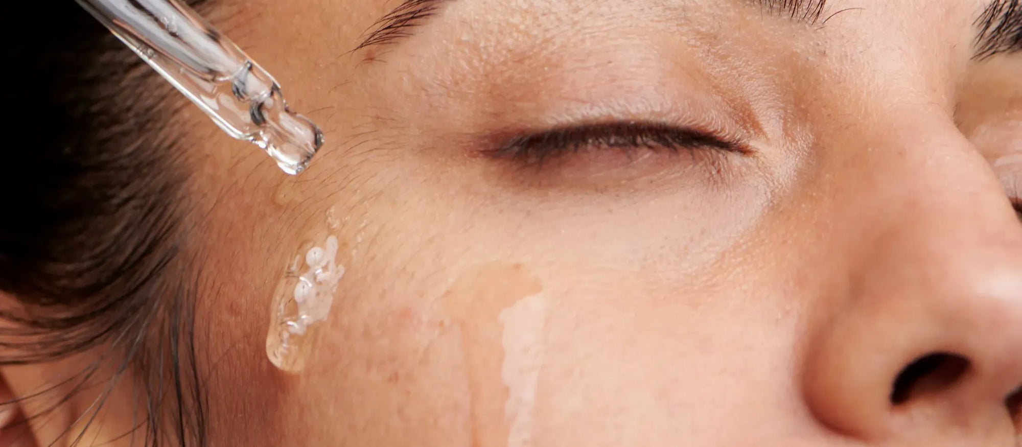 A collection of K-beauty skincare products showcasing trends for 2025, including serums and sheet masks.