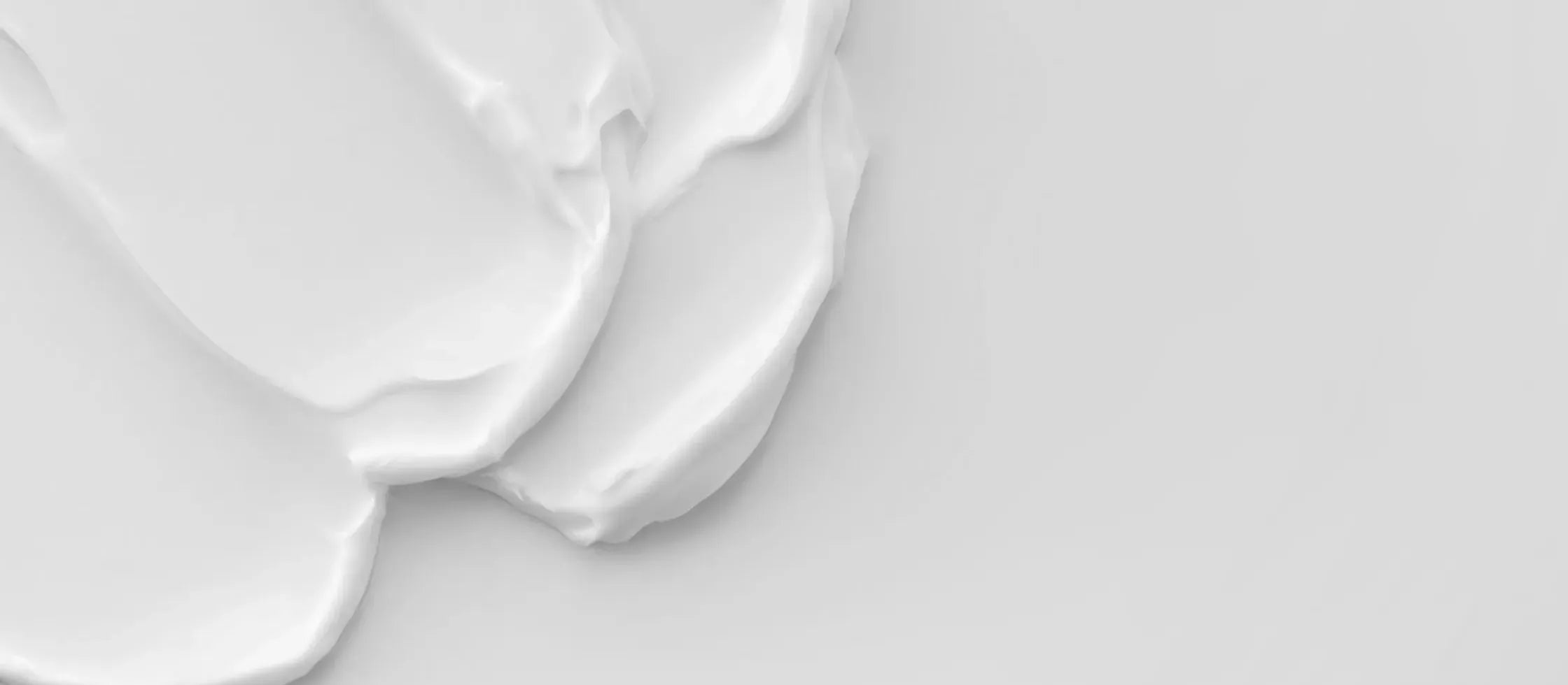 A side-by-side comparison of cream and gel-based sunscreens on a wooden table, highlighting their textures.