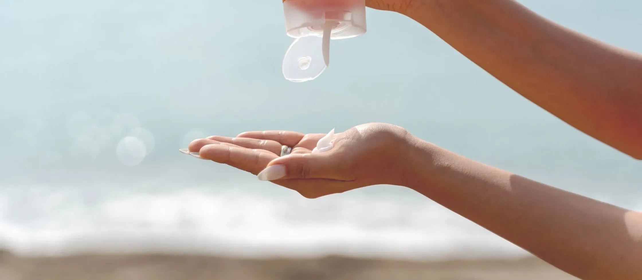 A woman applying sunscreen for dry skin in India, showcasing a range of sun protection products.