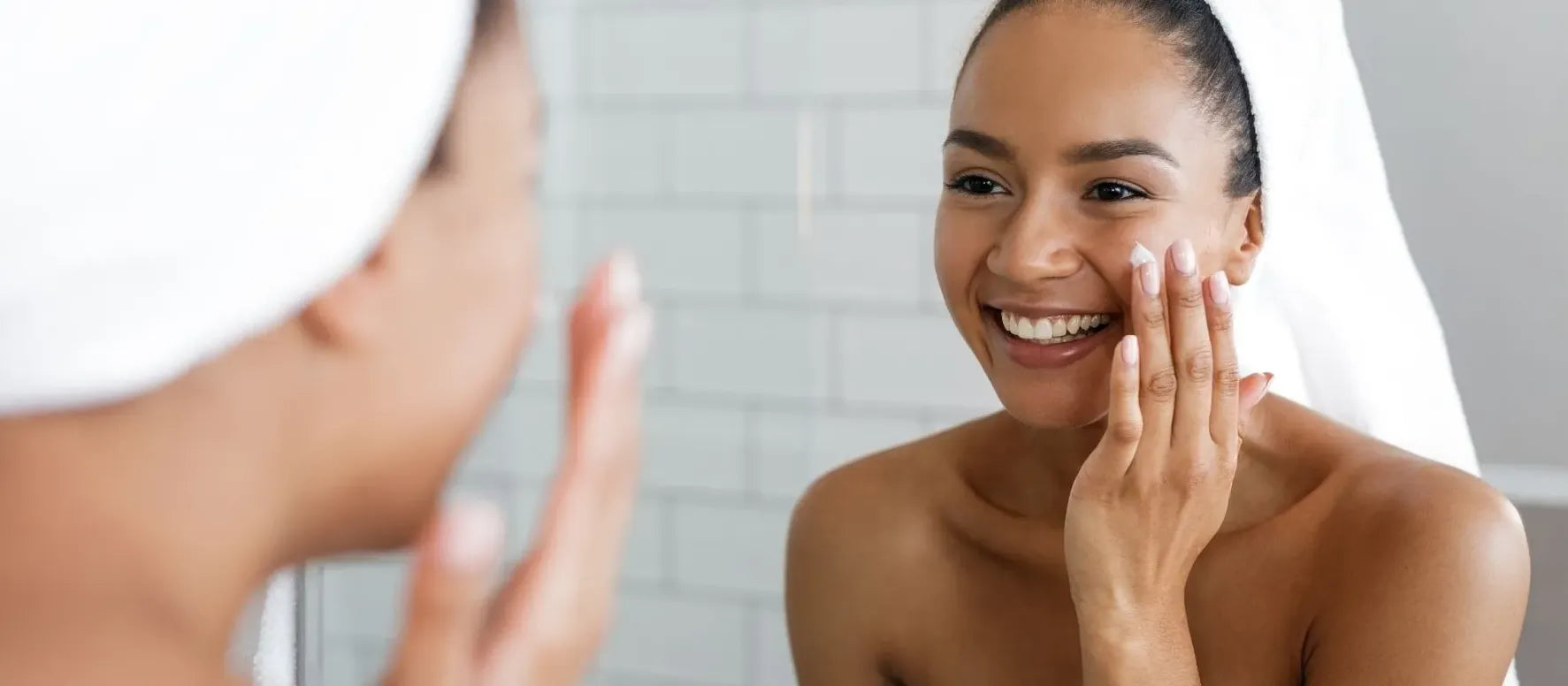 A person applying sunscreen using the 3-finger rule for effective sun protection on their arm.