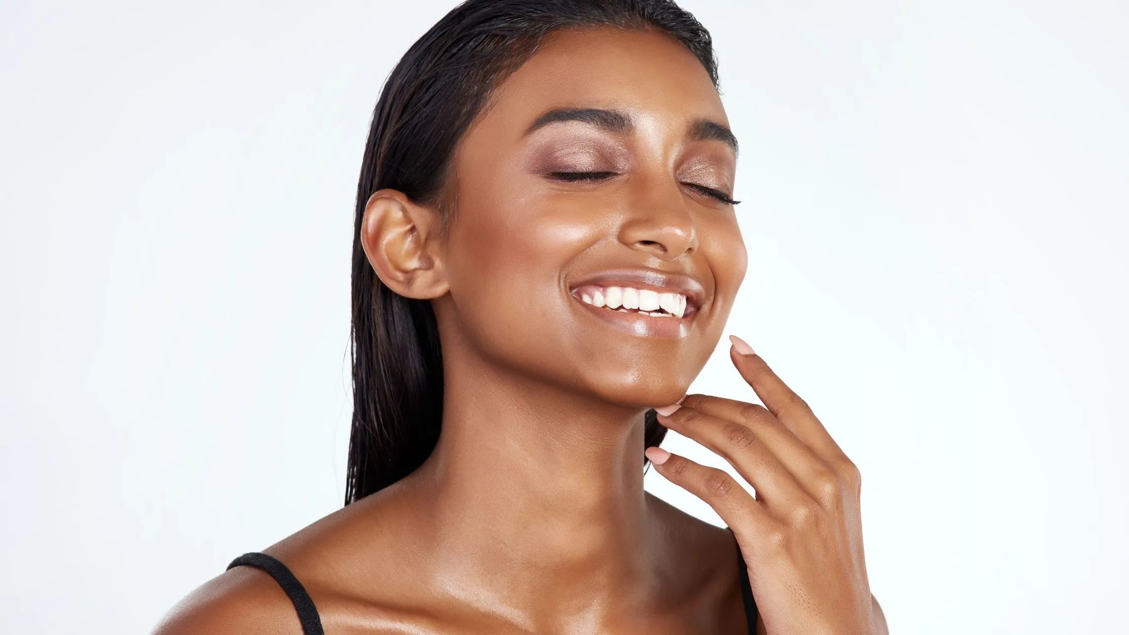 A person applying sunscreen using the pat method, ensuring even coverage for sun protection.