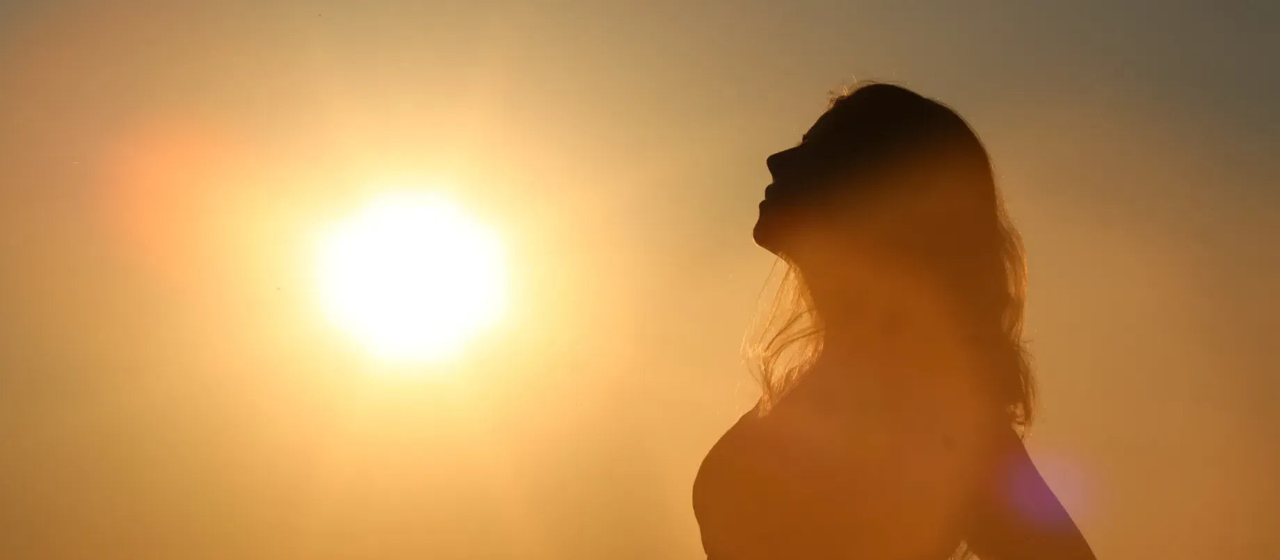 A person applying sunscreen on their arm, highlighting the importance of choosing the best sunscreen for body protection.