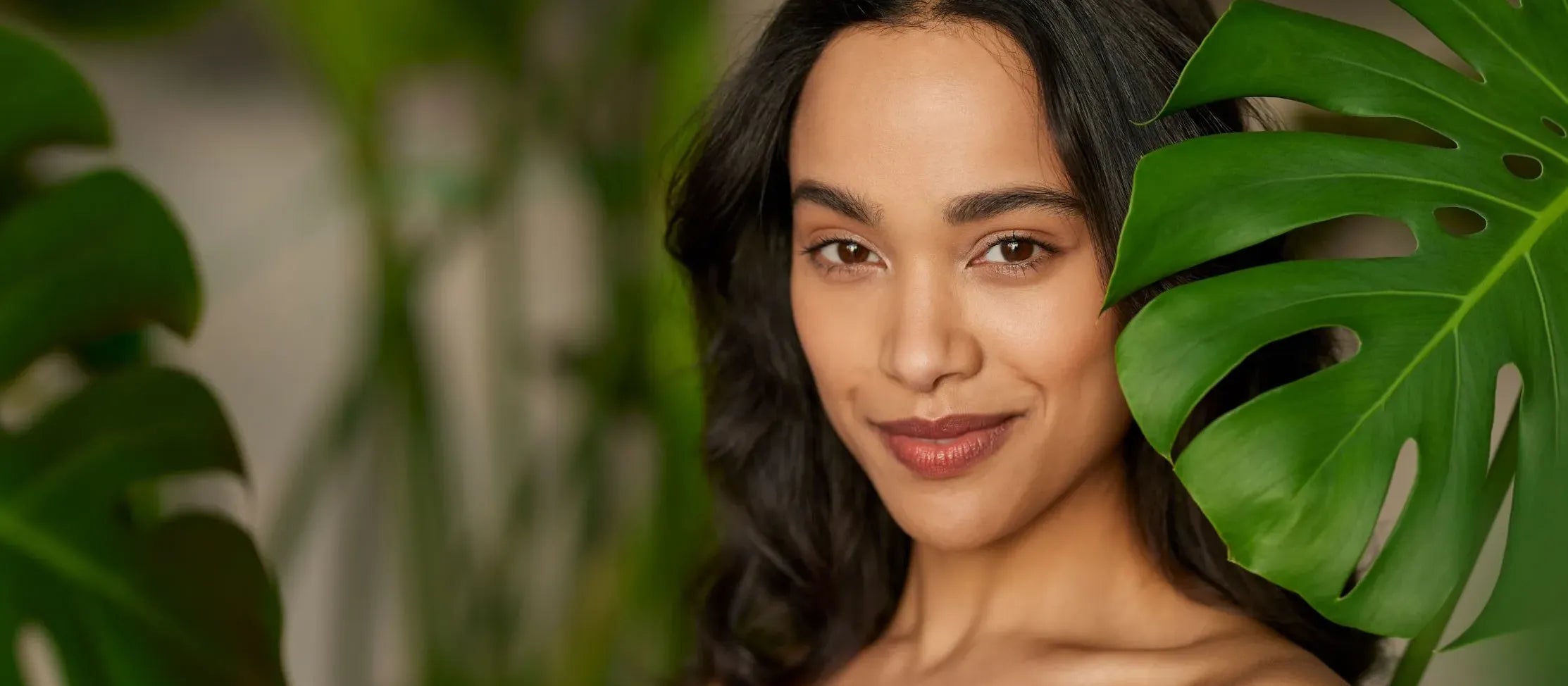 A person applying SPF 50 sunscreen on oily skin, highlighting its effectiveness and lightweight texture.