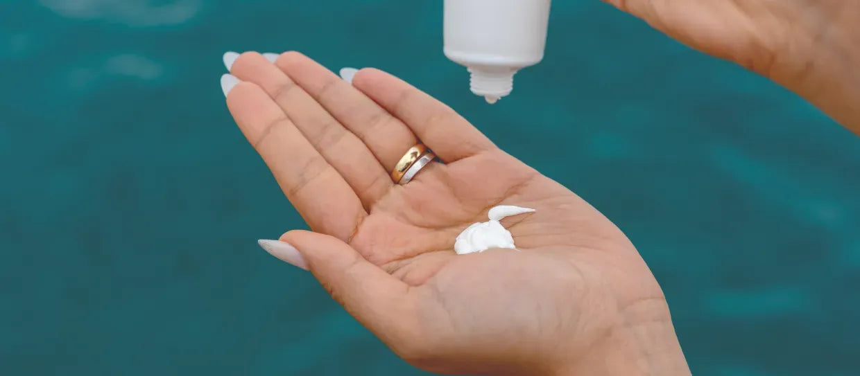 A person applying sunscreen with salicylic acid, exploring its benefits for skin health and sun protection.