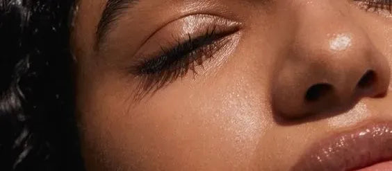 A woman examining various face washes targeting dark spots in India, showcasing skincare options for even skin tone.