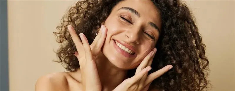 A person applying a gentle face wash for clear skin, showcasing a fresh and radiant complexion.