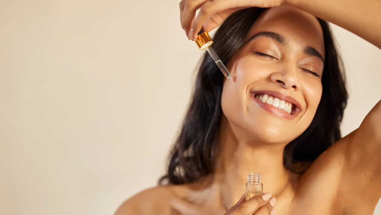 A woman applying anti-acne serum to her face, showcasing the benefits of clear skin and skincare routine.