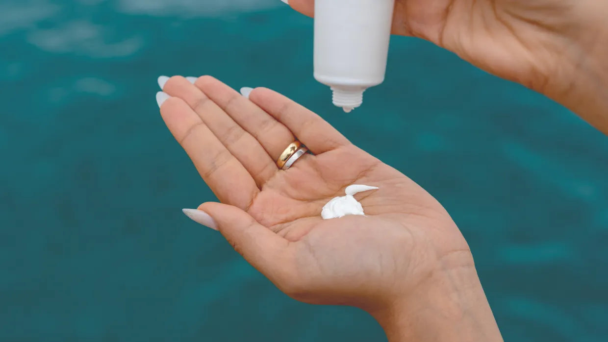 A person applying sunscreen on their face and body, showcasing essential sun protection tips.
