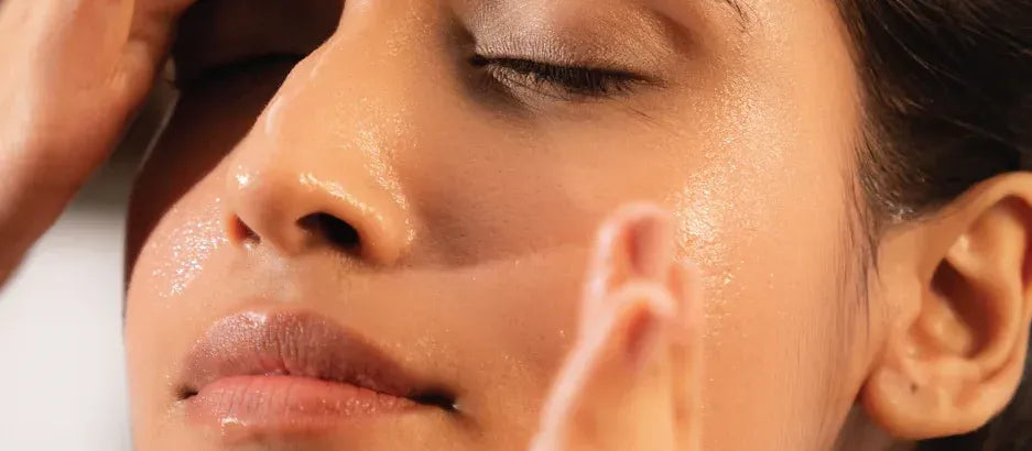 A woman applying salicylic acid sunscreen, showcasing radiant skin and sun protection benefits.