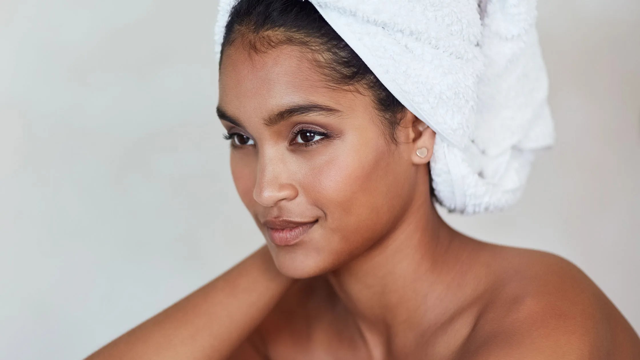 A bottle of dark spot remover serum surrounded by fresh ingredients, promoting skin transformation and clarity.