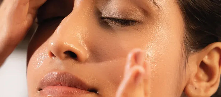 A woman applying a dark spot removal serum to her face, showcasing skincare solutions for women.
