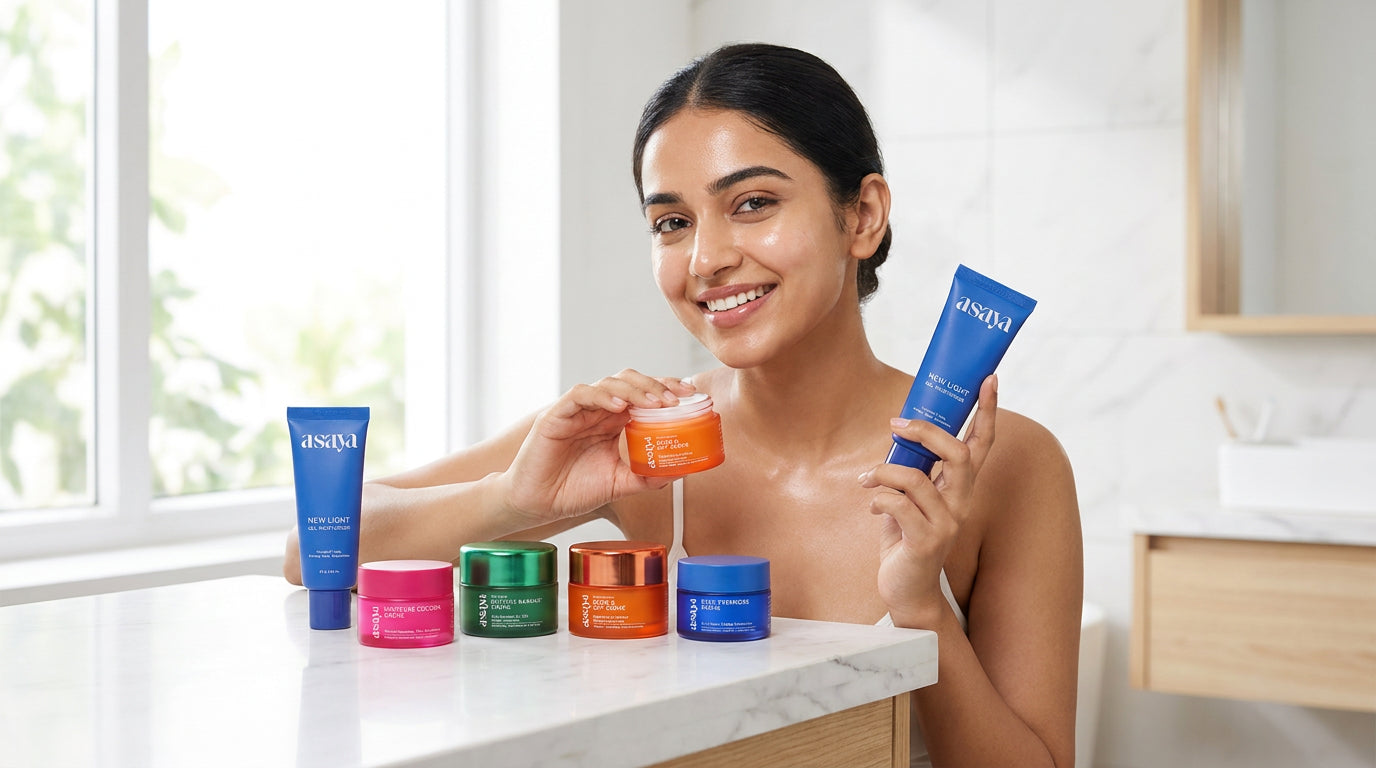 A smiling young indian woman applying skincare in a bright, minimal bathroom, holding a premium skincare set on a clean vanity, soft natural lighting, fresh glowing skin, elegant and aesthetic. 