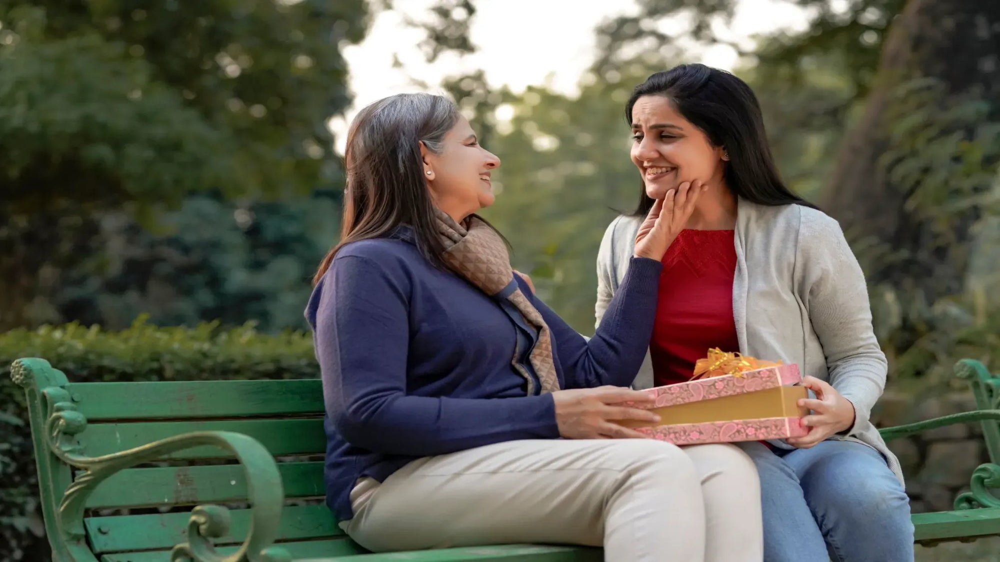 A woman with glowing skin applying a serum to reduce pigmentation and achieve radiant skin.