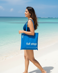 Young Indian woman with Asaya full stop tote bag on beach